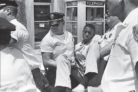 Danny Lyon, Eddie Brown Calmly Being Carried off by the Albany Police, 1963 (from Memories of the Southern Civil Rights Movement, copyright Danny Lyon/Magnum Photos)