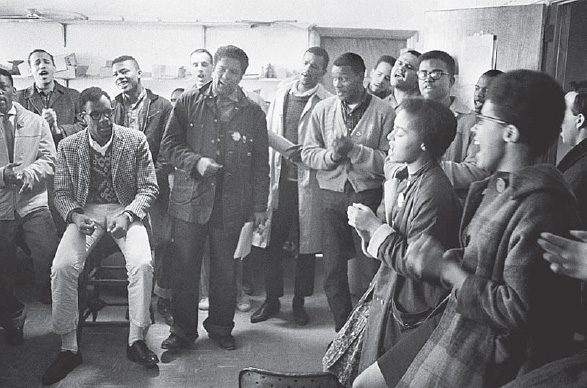 Danny Lyon, James Forman Leads Singing in the SNCC Office on Raymond Street in Atlanta, 1963 (from Memories of the Southern Civil Rights Movement, copyright Danny Lyon/Magnum Photos)