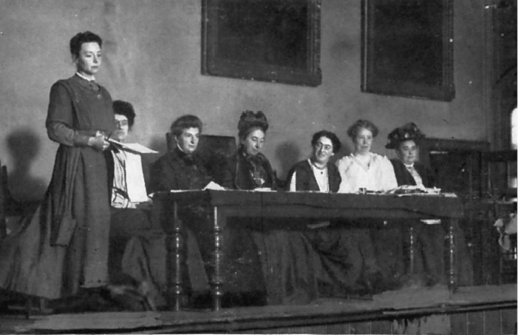 Plate 11. Katharine Bruce Glasier speaking at a Women’s Labour League meeting, c.1910. (L to r) Katharine Bruce Glasier, Mary Middleton, Minnie Nodin, Sister Kerrison, Marion Phillips, Mary Macarthur, Marion Curran.