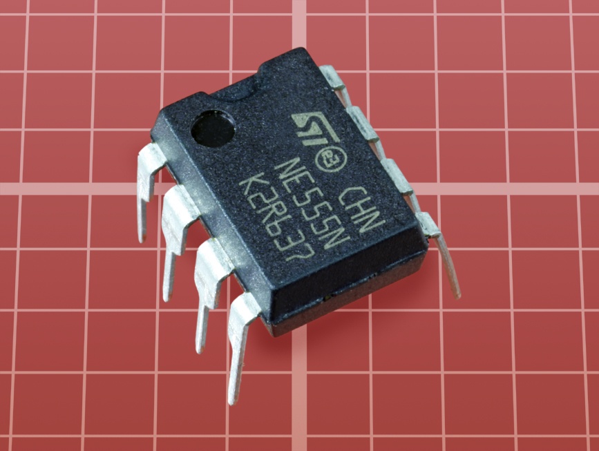 A typical 555 timer chip. Functionally identical versions in which the “555” identifier is preceded or followed by different letter combinations are available from many different manufacturers.