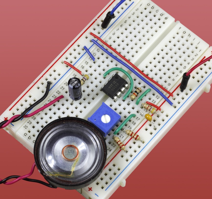 The components in the previous schematic are shown here mounted on a breadboard. They will generate an audio output ranging between approximately 425Hz and 1,075Hz. A lower value for the timing capacitor will shift the audio range higher in frequency.