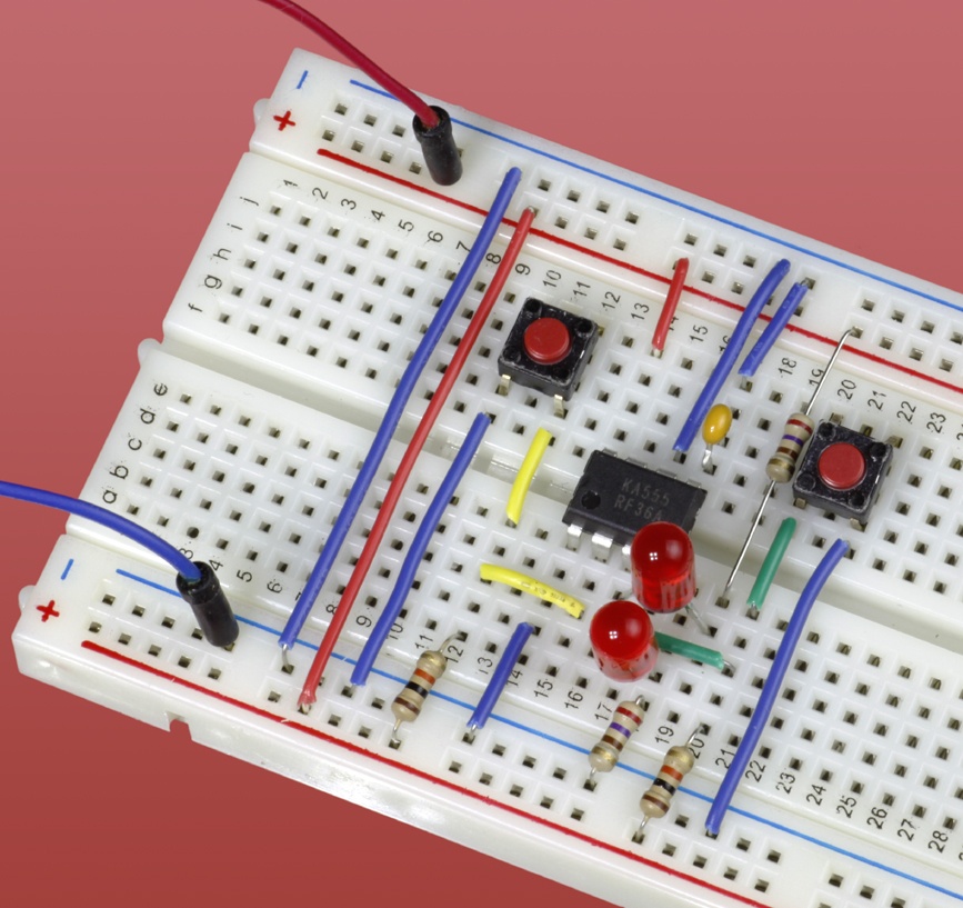 The schematic in which a 555 timer acts as a flip-flop is shown here adapted for a breadboard.