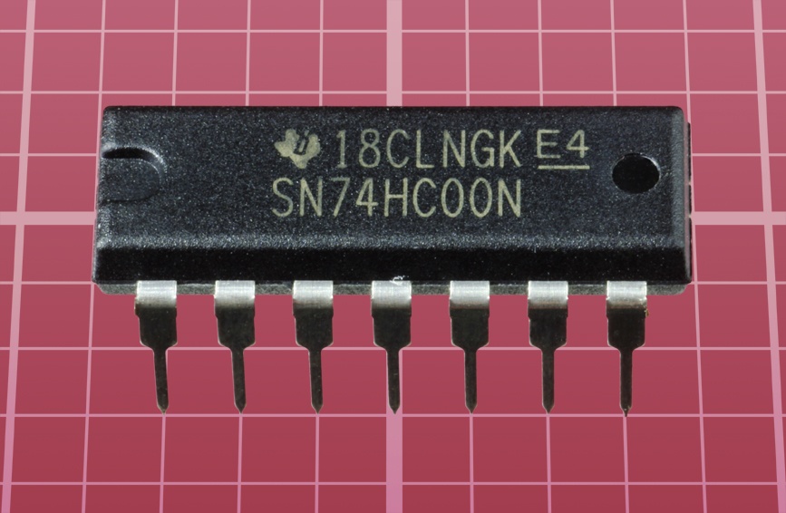 A modern version of a 7400 chip containing four NAND gates.