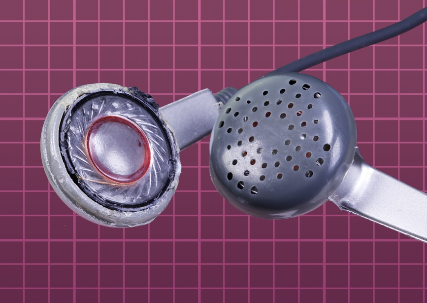 A pair of earbuds, one with its cover removed to show the sound reproducing element, which closely resembles the diaphragm in a full-sized headphone.