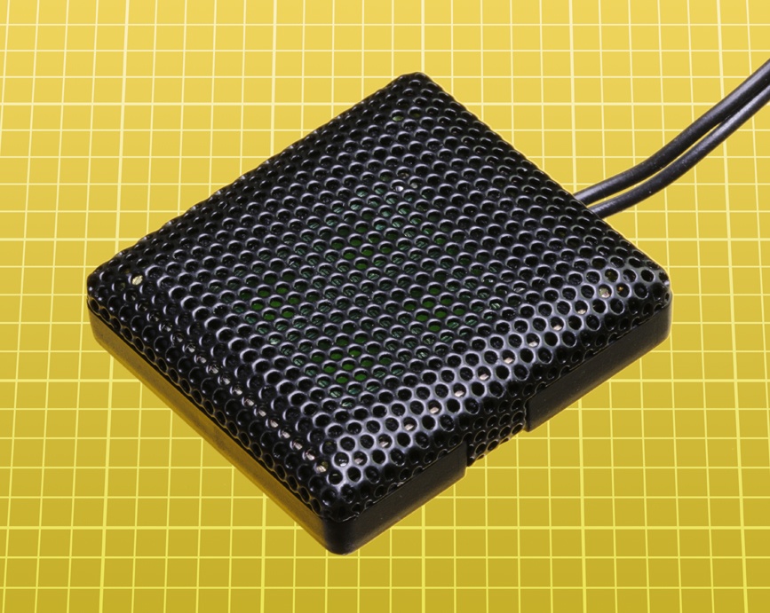 A speaker 1” square, suitable for use with a small electronic device.