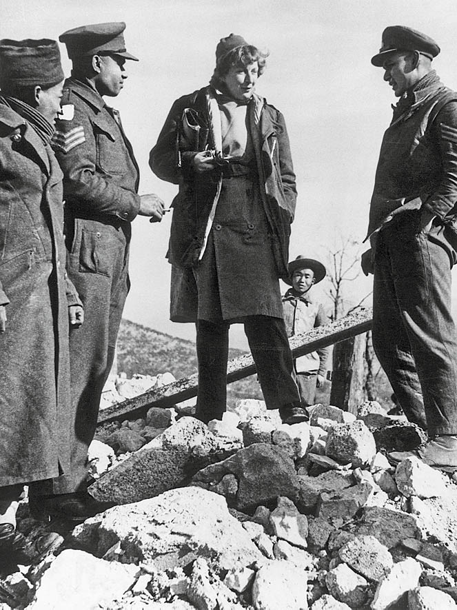 1944:  Journalist and writer Martha Gellhorn (1908 - 1998), wife of American writer Ernest Hemingway and the US war correspondent in Italy talks to Indian soldiers of the British Army on the 5th Army's Cassino front.  (Photo by Keystone/Getty Images)