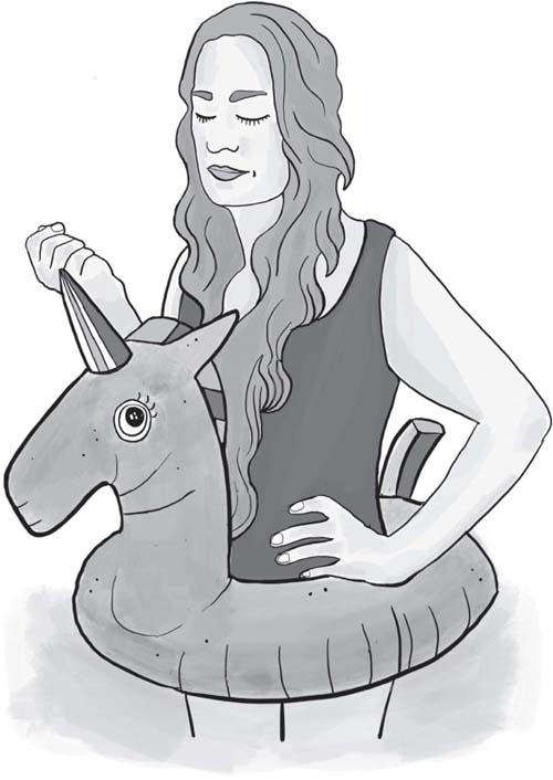 Feminine-presenting person with long hair standing casually, wearing a swimsuit and an inflatable unicorn used for swimming