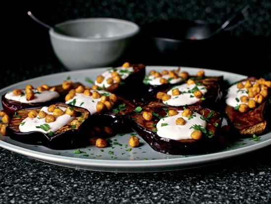 eggplant slices topped with chickpeas and white sauce