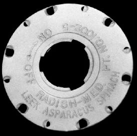 Disc for garden seeder with selected holes enlarged...