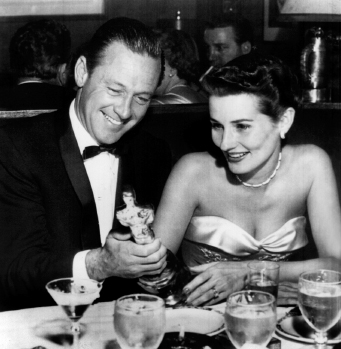 Bill with wife, Ardis, at Romanoff’s restaurant, holding his Oscar for Stalag 17.