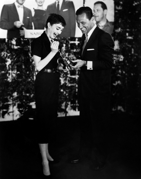 Back on the west coast, Audrey poses with Bill and her Oscar, a giant...