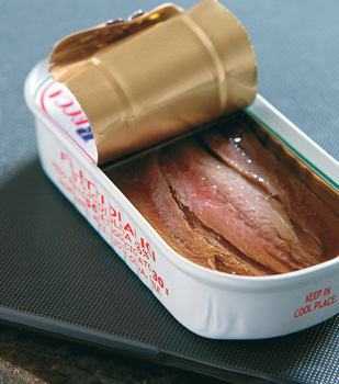 A tin of anchovies with the top lid rolled back