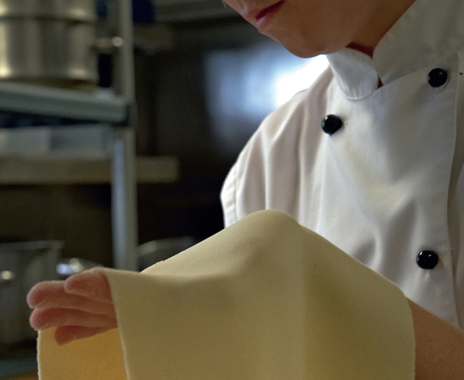 color image of a waiter holding a yellow napkin on his left hand continued from the previous page.