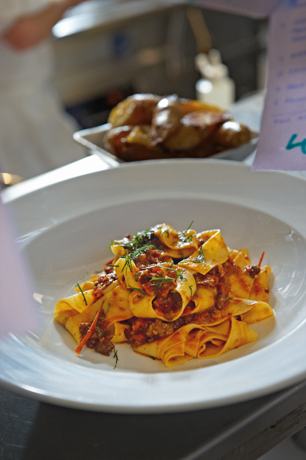 color image of WAGYU BOLOGNESE WITH HAND CUT FETTUCCINE with some sprinkles of parsley.