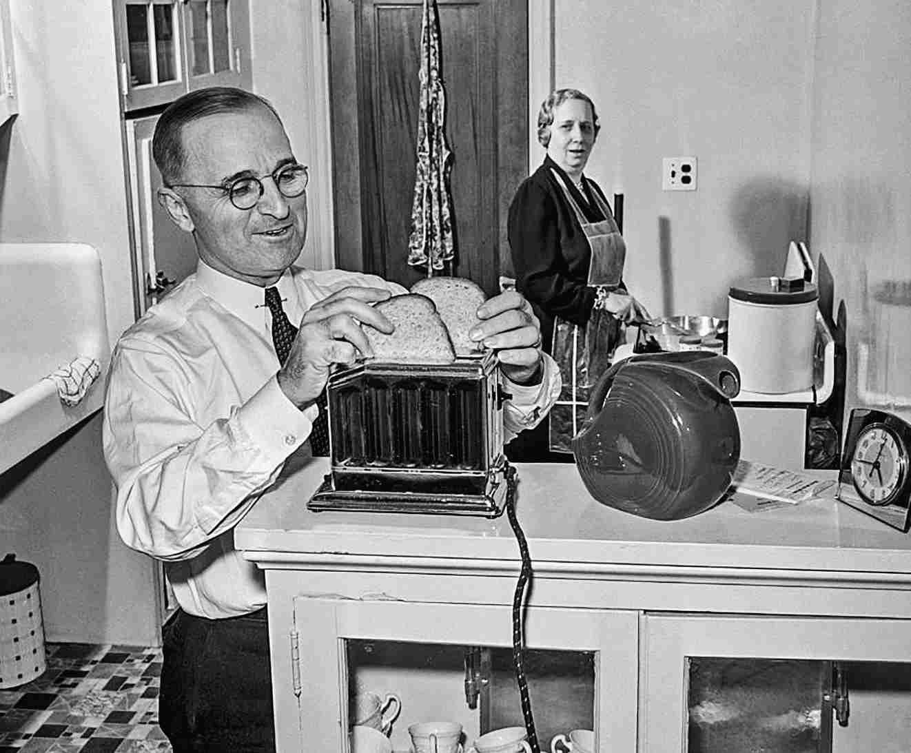 Missouri Senator Harry S. Truman helps his wife Bess make breakfast by putting bread in the toaster in their kitchen in Washington, D.C. Truman is predicted to be a candidate for Vice President of the United States.