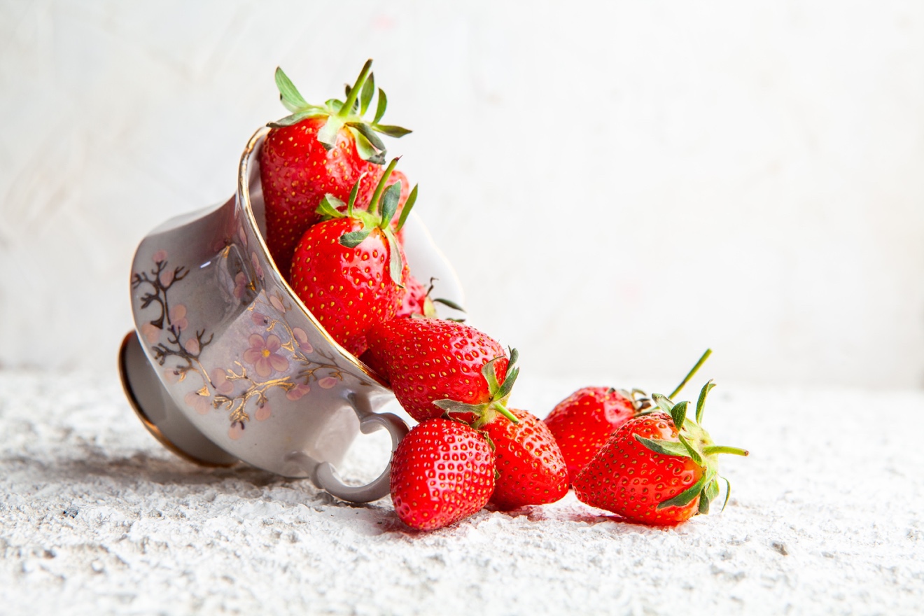 A cake with fruit on top of a table Description automatically generated