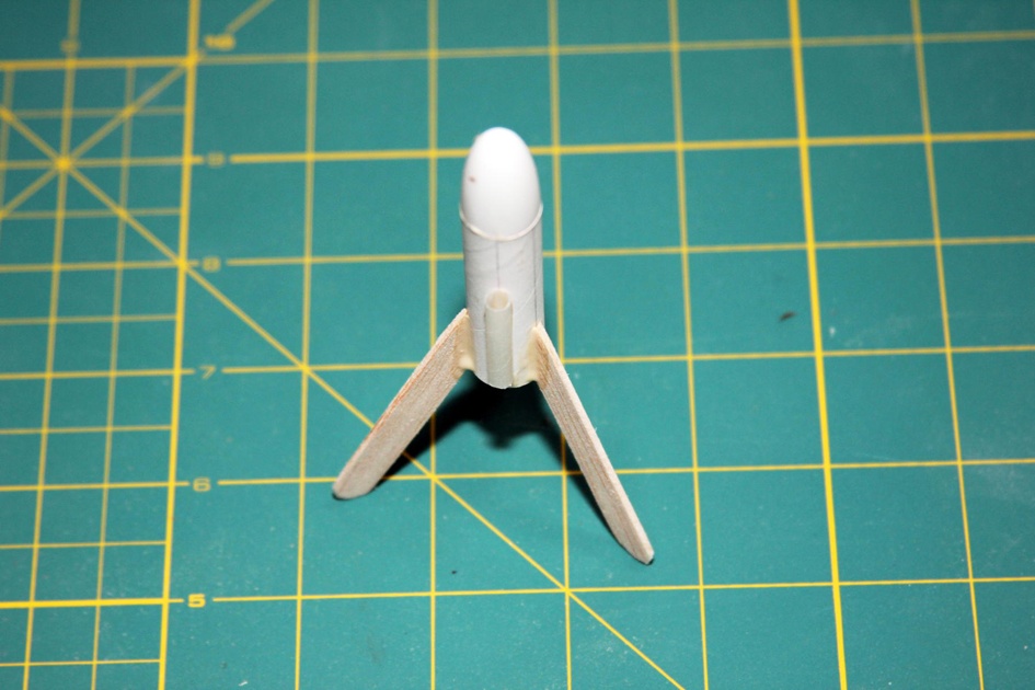 Glue on the nose cone and apply fillets to the fins.