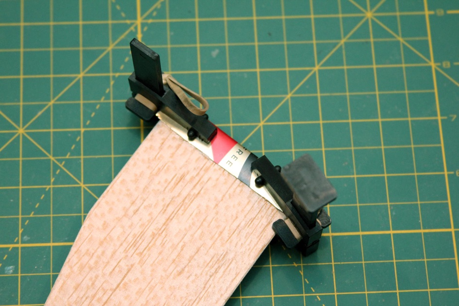 Use small clamps or a book to hold the wing root supports firmly in place while the glue sets.