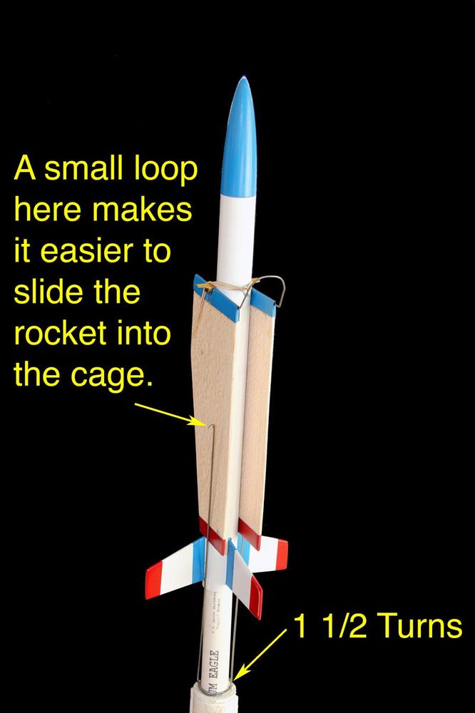 Use 24” of 1/16"-diameter wire to form a cage that pins the wings in place until the rocket launches.