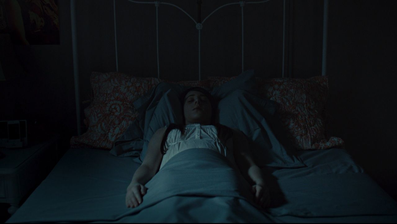 Frame from the Hannibal pilot with Will Graham finding a missing young woman murdered in her darkened childhood bedroom.