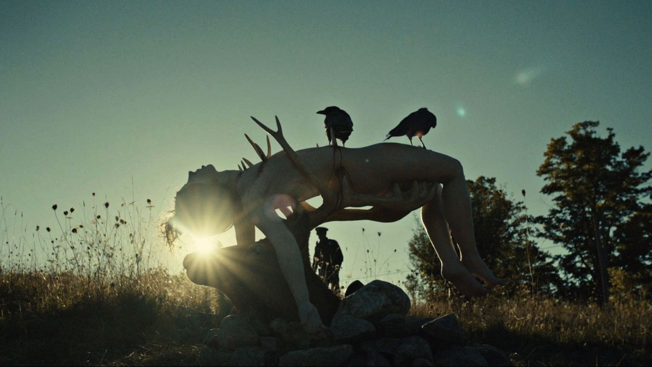 Frame from the Hannibal pilot with one of Hannibal Lecter’s victims, a young woman, impaled on antlers in a field and silhouetted by the rising sun.