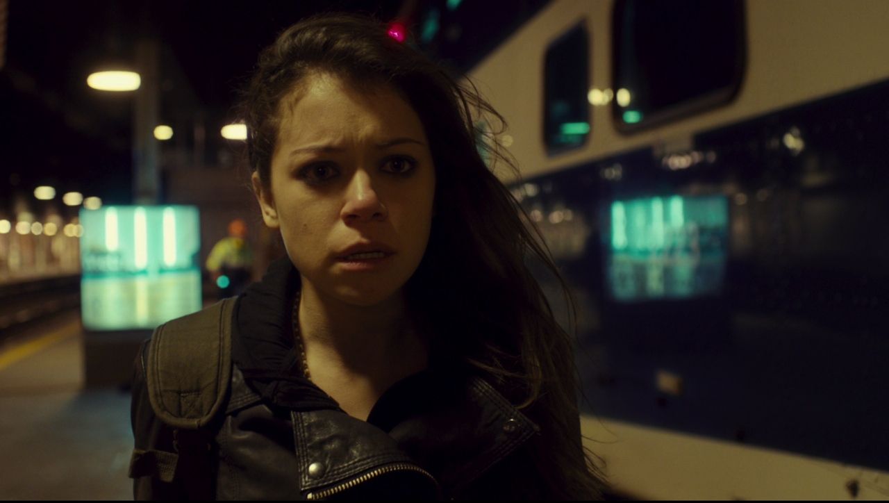 Frame from Orphan Black pilot showing closeup shot of Sarah Manning reacting in horror to a woman’s suicide in the subway.