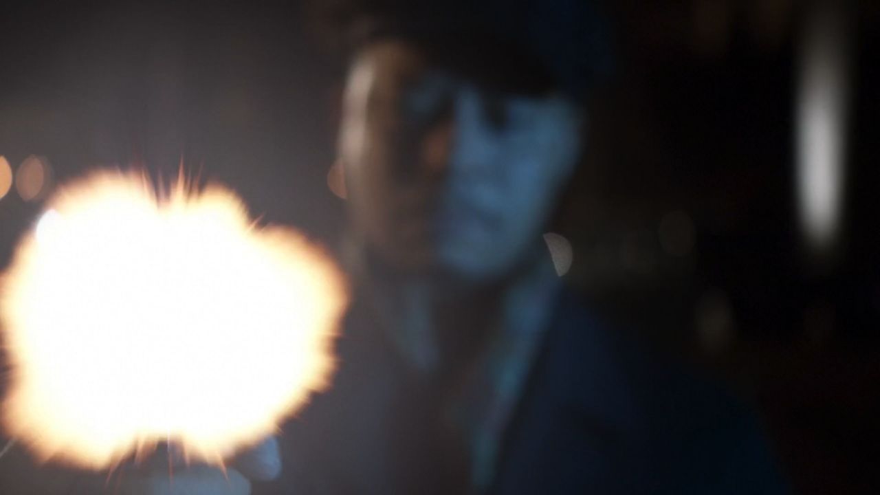 Frame from Empire pilot with Lucious Lyon’s face and the bright muzzle flash in the foreground as he kills a former friend.