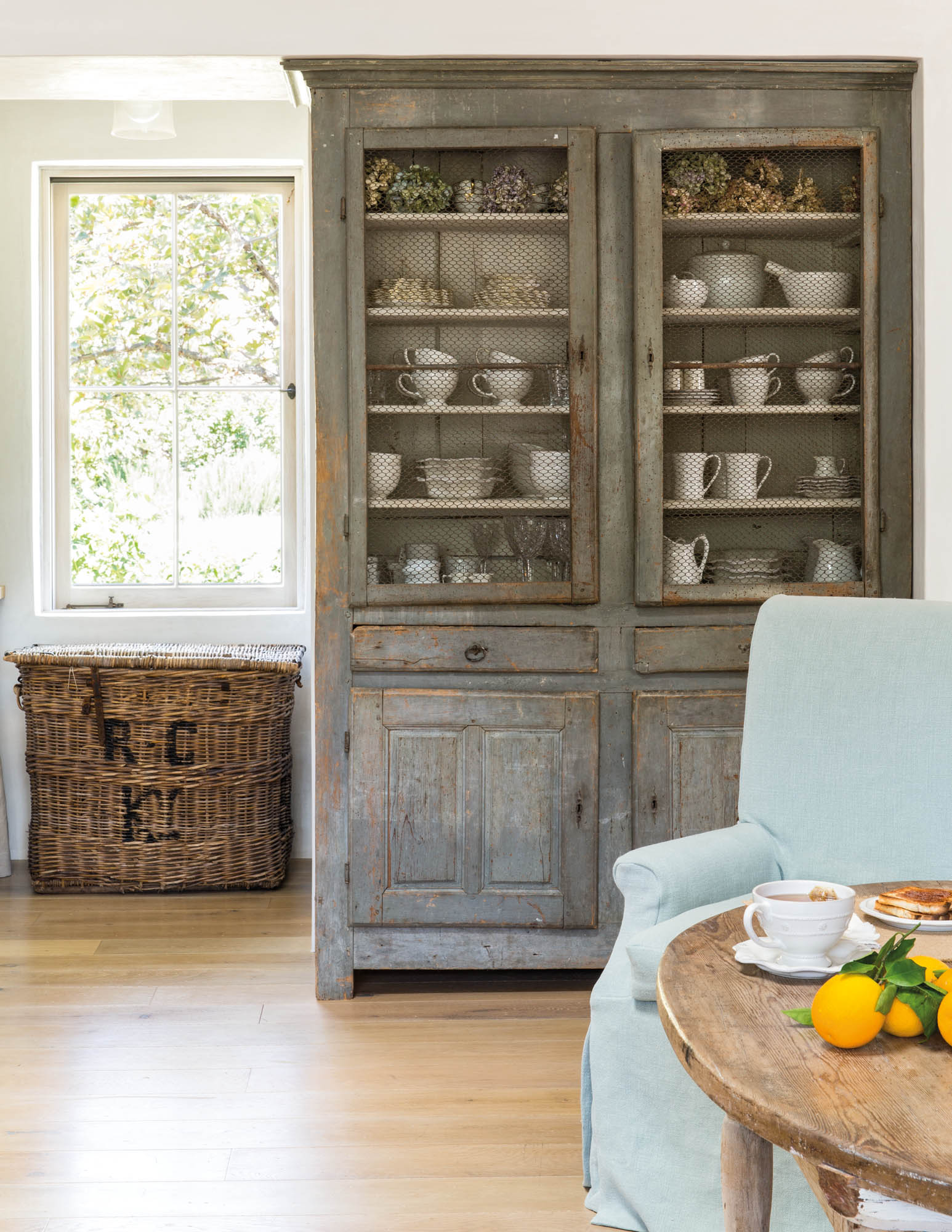 Photo of an antique French cabinet for storing our dishes and silverware.