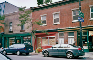 A sunny downtown street with boutiques and small restaurants