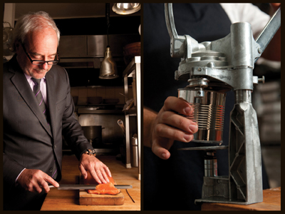 A man in a suit slicing salmon thinly and opening a can with mounted manual can opener