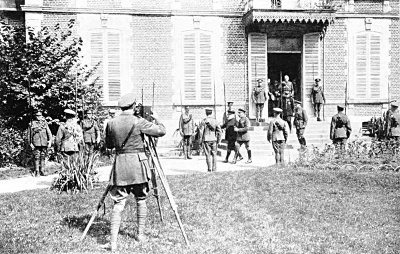 FILMING THE KING DURING HIS VISIT TO FRANCE IN 1916. HE IS ACCOMPANIED BY PRESIDENT POINCARÉ, SIR DOUGLAS HAIG, GENERAL JOFFRE AND GENERAL FOCH