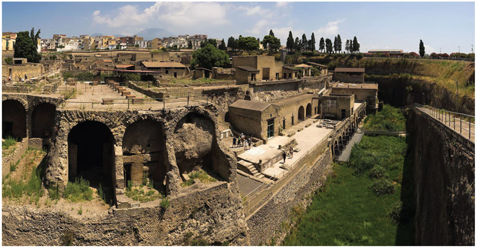 Figure 4.9. Herculaneum, a view of the port area. On the right it is possible to appreciate the dimensions of the tuff rock covering the city. Sarahhoa [CC BY-SA 2.0 (https://creativecommons.org/licenses/by-sa/2.0)]