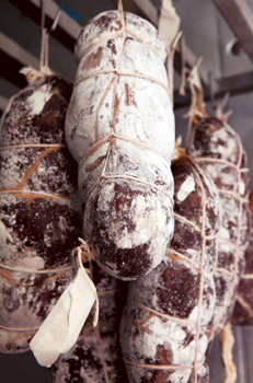 Cured, salted, meats, wrapped and hanging