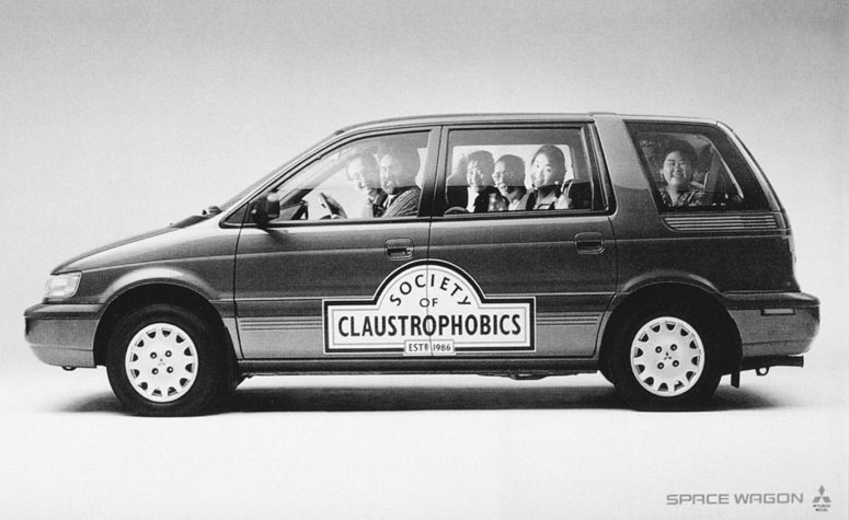 Figure depicting an ad for Mitsubishi's Space Wagon where 6 to 7 people are sitting on the car. “Society of Claustrophobics” is written on the side of the car.