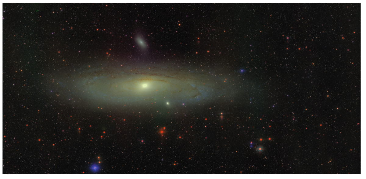  Andromeda galaxy from the Sloan Digital Sky Survey. The Andromeda galaxy is a spiral seen almost edge on, accompanied by two small elliptical satellite galaxies (M32 below, NGC205 above).  Sloan Digital Sky Survey and Doug Finkbeiner