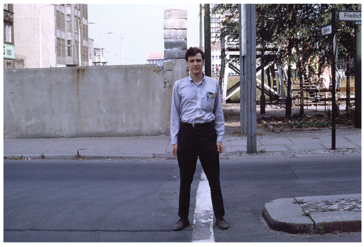  Rich Gott at the Berlin Wall in 1969. My right foot is in East Berlin, my left foot is in West Berlin, and the Berlin Wall is vertical behind me.   Collection of J. Richard Gott