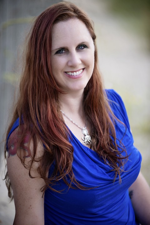 author Megan Hart in a  blue shirt and having a good hair day