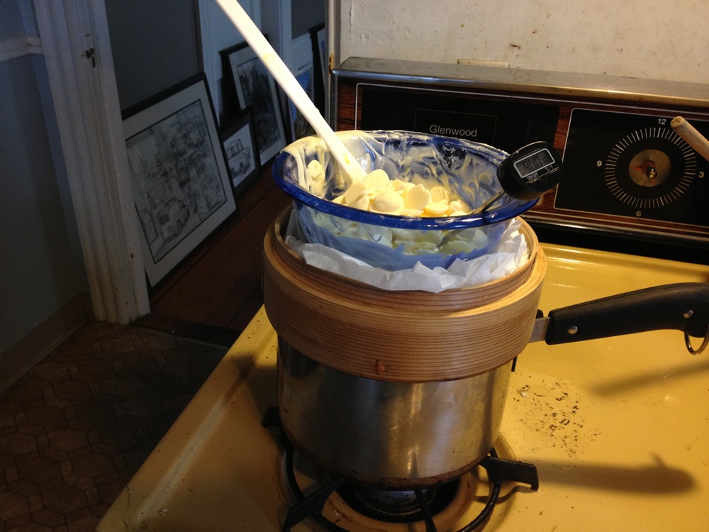 Melting chocolate in a glass bowl and a bamboo steamer.