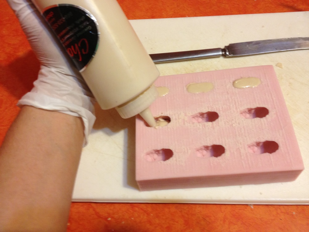 Using a squeeze bottle to pour the chocolate into the mold