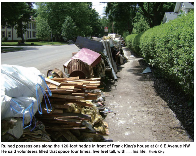 Ruined possessions along the 120-foot hedge in front of Frank King’s house at 816 E Avenue NW. He said volunteers filled that space four times, Ave feet tall, with . . . his life. Frank King