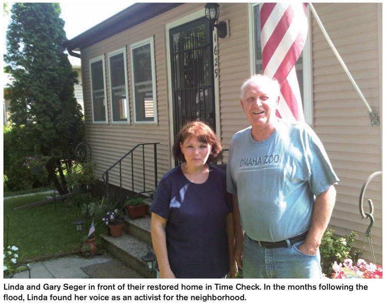 Linda and Gary Seger in front of their restored home in Time Check. In the months following the flood, Linda found her voice as an activist for the neighborhood.