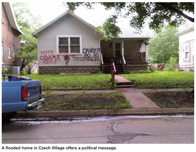 A flooded home in Czech Village offers a political message.