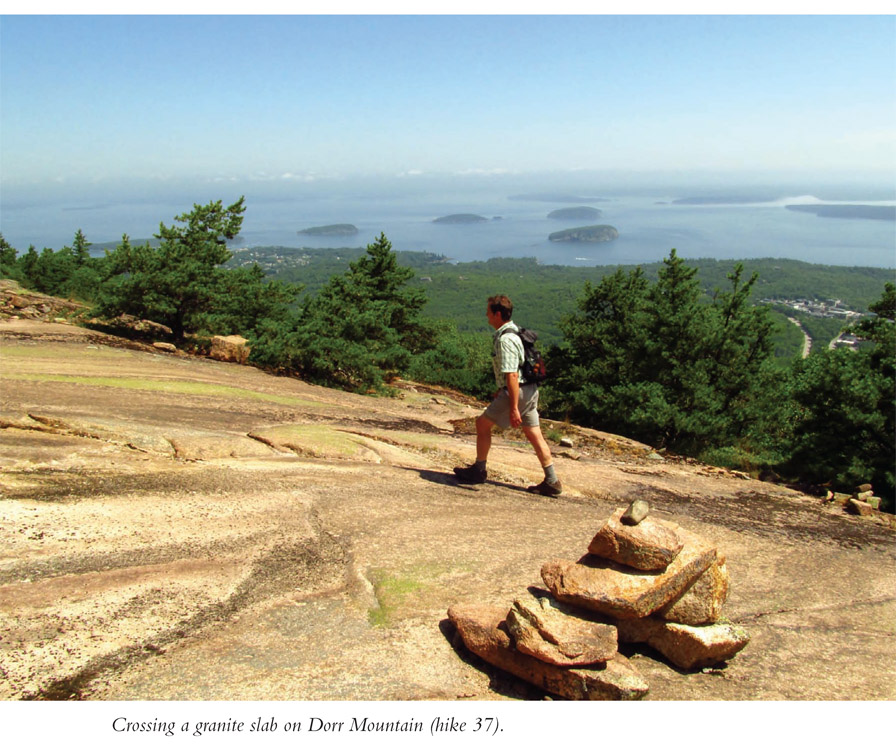 Crossing a granite slab on Dorr Mountain (hike 37).