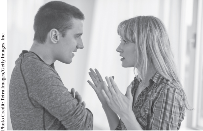 Photograph of a man and woman conversing with each other.