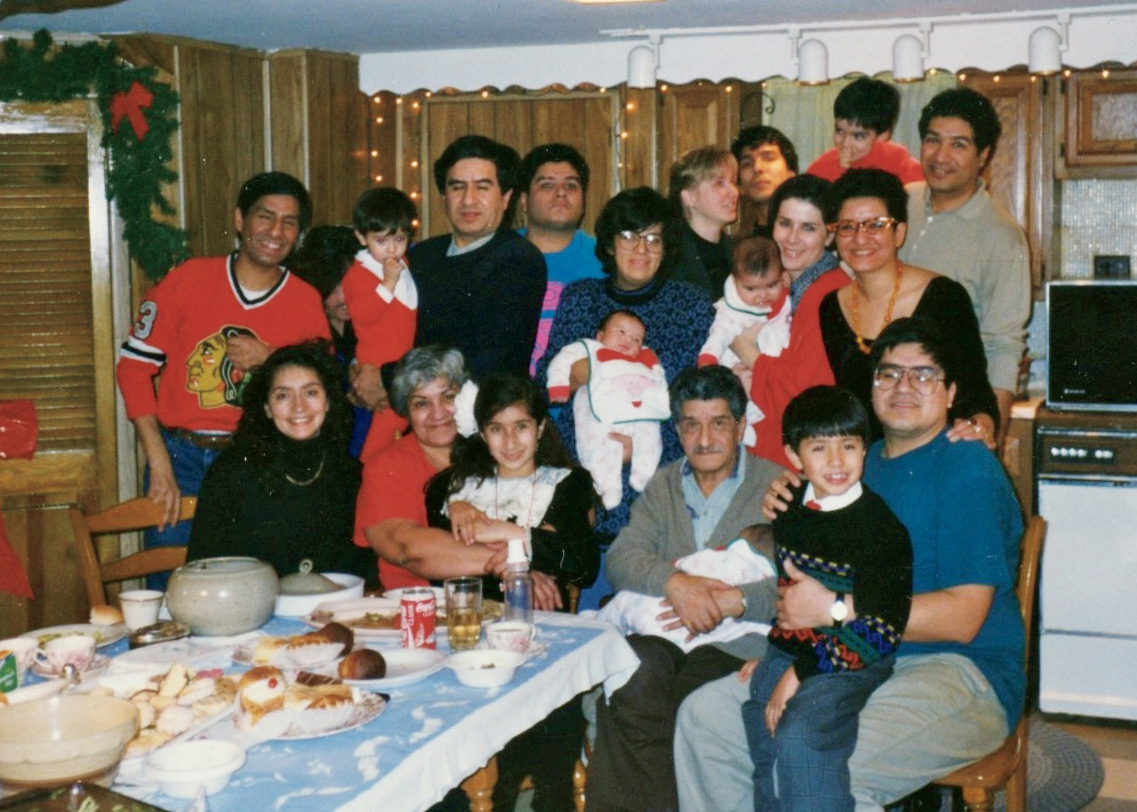 A moment after the Cisneros Family Christmas, with pastries still on the table in my mother’s basement kitchen, Keeler house; I’m standing on the far right, second row.