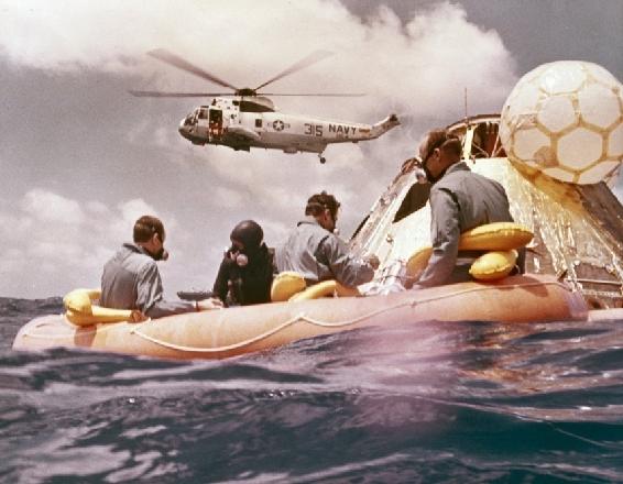 Navy swimmer in the water took this picture of the astronauts in the liferaft