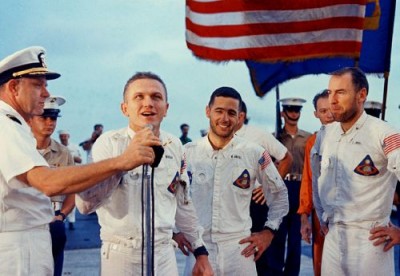 Frank Borman alongside Bill Anders and Jim Lovell speaks abourd USS Yorktown