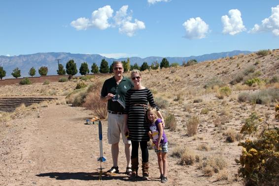 Three generations of rocketeers getting rockets ready for flight.