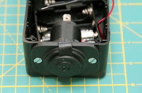 Here is the front of the cigarette lighter socket with the plastic cover closed. Note that it sits about 1/16” above the lip of the box. The lid will add some height so the socket fits well, but we need all the room we can get inside the box!