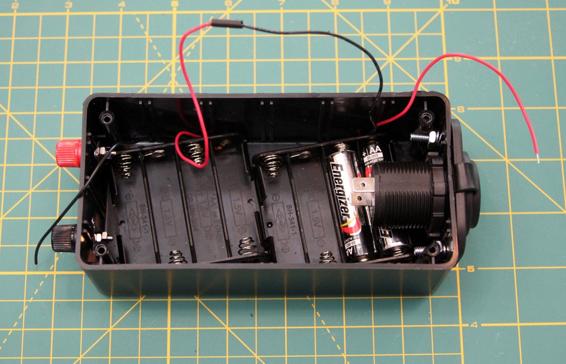 Solder the red wire from one battery holder to the black wire of the other.